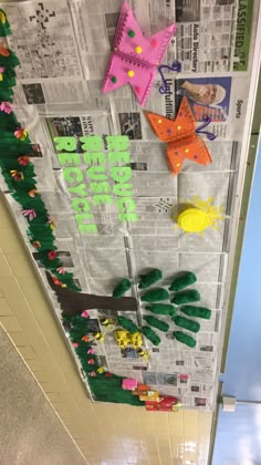 the bulletin board is decorated with paper cut outs