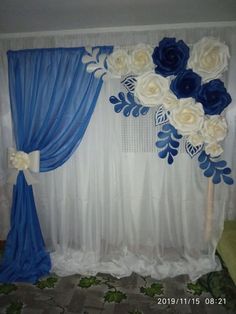 blue and white flowers are on the curtain