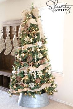 a christmas tree decorated with ribbon and ornaments