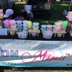 there are many cups on the table at this vendor's booth that is selling them