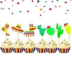 cupcakes decorated with mexican decorations and confetti sticks on a white background