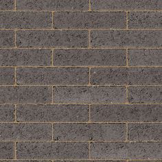 a brick wall that is grey and brown with some yellow lines on the bottom half