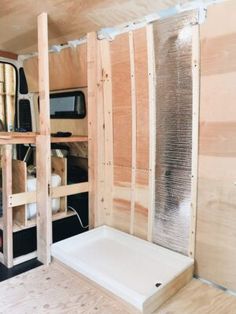 the inside of a truck with wood paneling on the walls and shelves in it