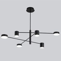 a black chandelier with five lights hanging from it's center and four circular shades