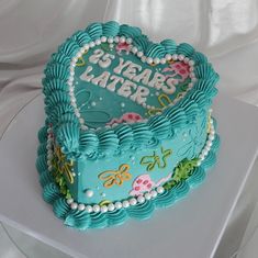 a heart shaped cake with the words 25 years later on it