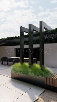 an outdoor area with tables, chairs and green plants on the ground in front of it