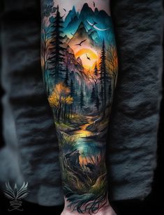 a man's arm with an image of mountains, trees and birds on it