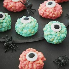 halloween treats with eyes and spider webs are on a black plate, ready to be eaten