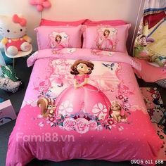 a bed with pink comforter and pillows in a child's bedroom, it has hello kitty on it