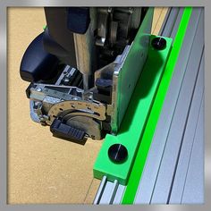 a close up view of the side of a machine with green tape on it's sides