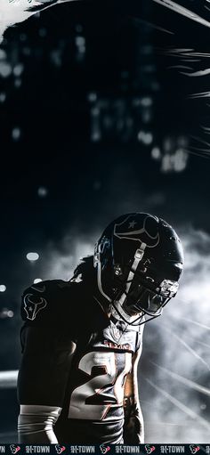 a football player wearing a black uniform and helmet