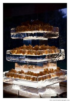 three tiered trays filled with food on top of ice