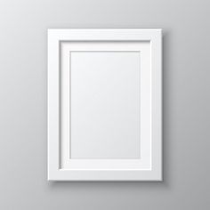 a white frame hanging on the wall with an empty space for text or image in it