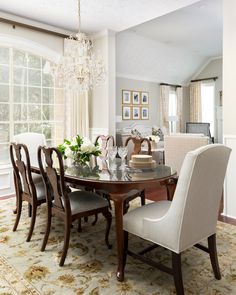 a dinning room table with chairs and a chandelier