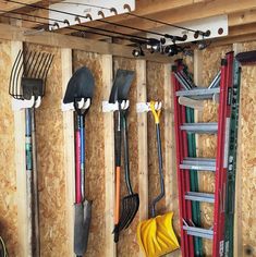 several different tools are hanging on the wall