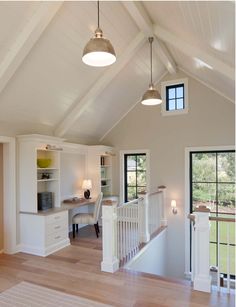 an open floor plan with white walls and wood floors