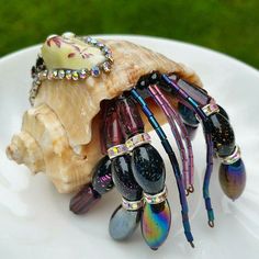 a white plate topped with lots of colorful jewelry