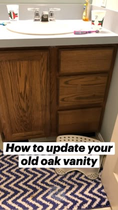 a bathroom with blue and white rugs on the floor next to a wooden cabinet