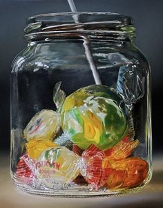 a jar filled with gummy bears sitting on top of a table