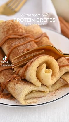 cinnamon roll protein crepes with peanut butter drizzled on top