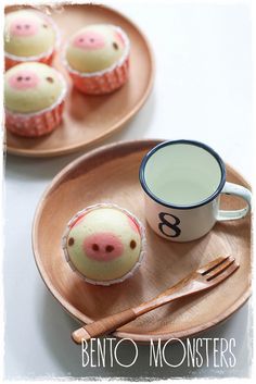 two plates with cupcakes on them and one has a pig face