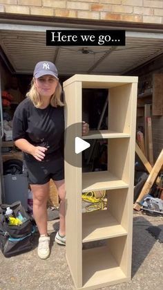 a woman standing next to a book shelf with the words here we go on it