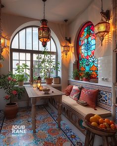 a room with stained glass windows, potted plants and fruit on a table in front of the window