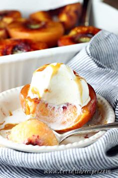 a bowl filled with baked peaches and ice cream