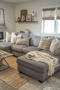 a living room filled with furniture and a fire place next to a window on top of a rug