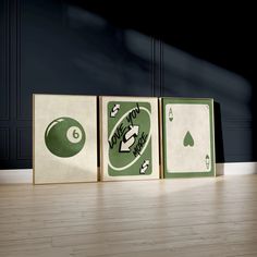 three different sized playing cards sitting on top of a hard wood floor