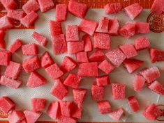 chopped up watermelon pieces on a cutting board