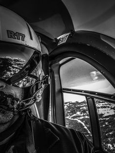 a man wearing a helmet while sitting in an airplane