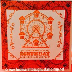 an orange and white birthday card with a ferris wheel in the middle, on a red background