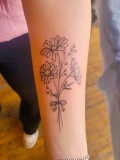 a woman's arm with flowers on it