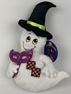 a stuffed snowman with a black hat and purple mask