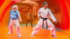 two men are doing karate in front of an orange background