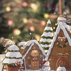 a christmas scene with gingerbread houses and snowmen