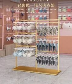 a display case filled with lots of white and blue dishes in front of a pink wall