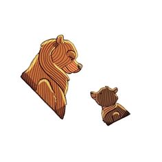 a bear and cub pin sitting next to each other