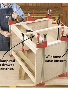 a man is working on a cabinet in the process of being assembled with woodworking tools