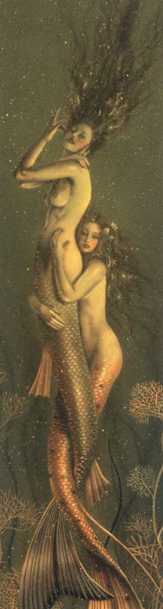 two mermaids are hugging in the water