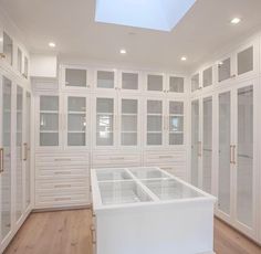 an empty room with white cabinets and glass doors on the walls is seen in this image