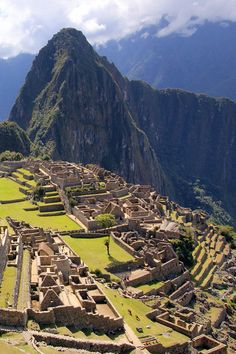 an aerial view of the ancient city of machaca picach, with mountains in the background