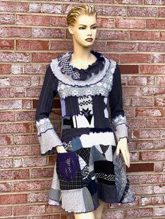 "This cowl neck sweater dress is handcrafted bohemian clothing for women. I made this sweater tunic from non-wool knit fabric scraps, color block - black and white pieces in a fantasy patchwork style. The patchwork sweater features a cowl neck collar, hand-crocheted pocket, and ruffle reversible seams. The sweater is wearable art apparel and can be a perfect clothing gift for any woman! Size Medium/10-12 * Bust - 36-38 inches, stretchy * Sleeves - 22 inches * Length - 34-36 inches (slightly asymmetrical) * Color block: Black and white palette with purple tread reversible seams * Care instruction: Hand or machine wash, low tumble dry. NOTES: * Modeled on a size small mannequin. * The standard clothing size chart is attached to the last picture. * If you have any questions before purchasing, Artisan Clothing, Wearable Art Fashion, Zero Waste Fashion, Boho Mode, Patchwork Sweater, Cowl Neck Sweater Dress, Handmade Sweater, Repurposed Clothing, Bohemian Clothing