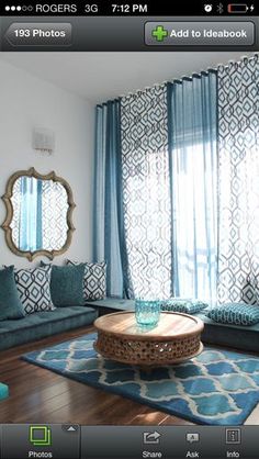 a living room filled with furniture and blue curtains