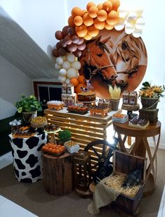 an animal themed dessert table with balloons and other food on it's sides, including carrots