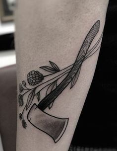 a black and white photo of a person's arm with a tattoo on it