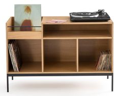 a record player is sitting on top of a shelf