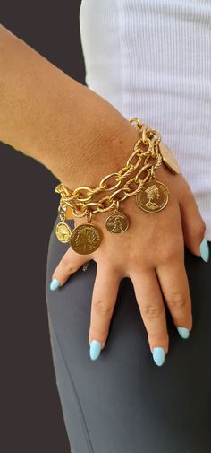 ♦  A beautiful gold bracelet is designed in two layers of link chains and decorated with 8 different coins.      The bracelet is made of Matt gold-plated brass and 2 coins from silver-plated brass.      The bracelet is full of presence and style.                                                                                                                                                             The length ranges from 6.3"(16 cm) to 8.2"(21 cm). If you want a different length, please update me when you place your order.     Width chain: 0.79"( 2cm)     Width coin between 0.39" (1cm) - 0.98" (2.5cm  )   ◾   The bracelet came in 2 colors: matt Gold And Silver oxide.     ◾ Please note: the matte finish contains nickel. Please make sure you are not sensitive to nickel, before     purchasin Coin Charm Bracelet, Double Chain Bracelet, Gold Link Bracelet, Coin Bracelet, Link Chain Bracelet, Trendy Fashion Jewelry, Gold Link, Double Chain, Coin Pendant