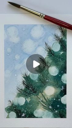 a watercolor painting of a christmas tree with snow on it and a red brush next to it